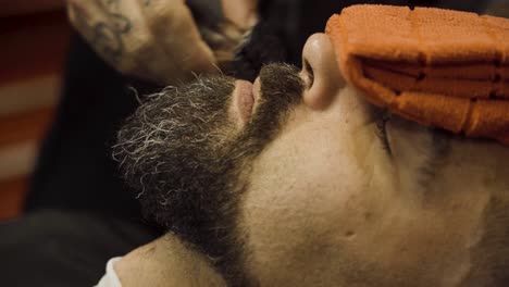 Barber-Cuts-The-Client's-Mustache-With-A-Shaving-Machine---close-up