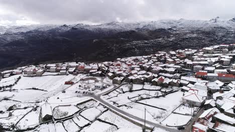 Village-with-snow-capped-mountains-Aerial-View