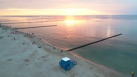 Experience-the-breathtaking-beauty-of-a-summer-sunset-on-a-picturesque-Baltic-Sea-beach,-captured-perfectly-by-a-drone