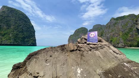 No-Picture-Sign-in-Maya-Bay-in-Phi-Phi-Islands-National-Park,-wave,-sand-beach,-and-beautiful-crystal-clear-water-at-a-popular-tourist-destination-in-Krabi,-Southern-of-Thailand