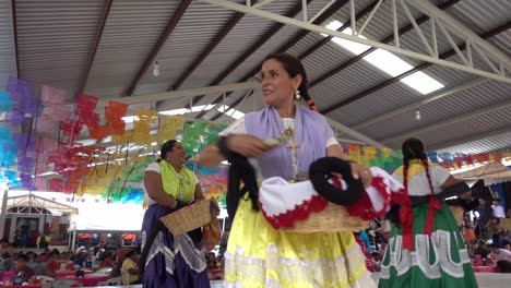 Slow-motion-shot-of-a-Mexican-woman-throwing-out-gifts-at-the-guelaguetza