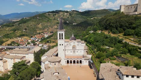 Aerial-View-Of-Spoleto-Cathedral-And-Bell-Tower-With-Rocca-Albornoziana-In-Background-On-Hill-Top