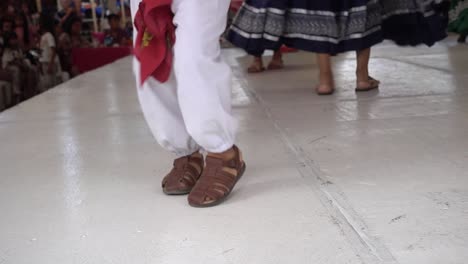 Slow-motion-shot-of-men-and-womens-dancing-feet-on-stage-at-guelaguetza