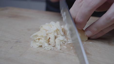 finely-cut-and-chopping-a-hemisphere-of-palm-sugar-with-a-sharp-kitchen-knife