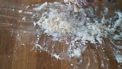 Hands-of-Baking:-Senior-Baker's-Slow-Mo-Closeup---Applying-Flour-and-Kneading-Traditional-Bread