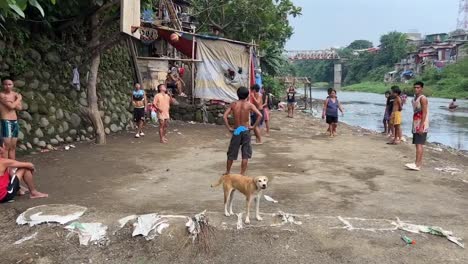 people-in-the-slums-playing-basketball-alongside-a-dirty-river-in-jakarta-indonesiav