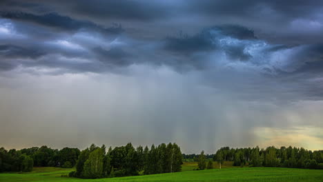 Cinematic-time-lapse-of-fast-moving-storm-clouds-over-a-grassy-landscape-with-trees-with-sun-rays-coming-through-the-clouds