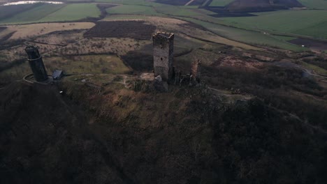 Top-view-drone-reveal,-medieval-Hazmburk-Castle-tower-on-hilltop,-Czech-Republic
