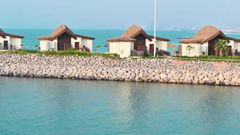 Overwater-villas,-huts-at-the-coastline-of-Ras-Al-Khaimah-in-the-United-Arab-Emirates