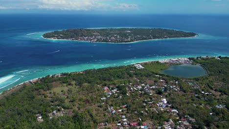 Aerial-view-of-Two-Islands-in-the-middle-of-the-ocean-in-Indonesia---Gili-Meno-and-Gili-T-at-the-background-with-it-stunning-turquoise-water-beach-shore