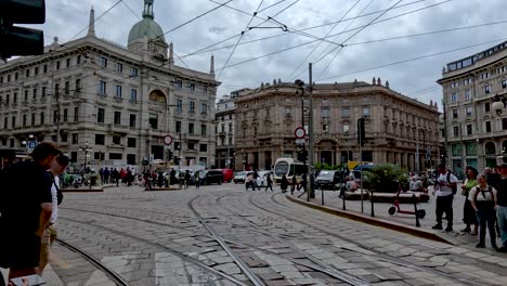 Traffic-Going-Past-Piazza-Cordusio-In-Milan-With-Yellow-Tram-Series-7500-In-Background