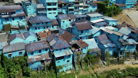 Arema-Blue-VIllage,-or-Blue-village,-an-old-slum-transformed-in-a-touristic-place-with-its-blue-houses-in-the-bank-of-the-river---Malang,-East-Java,-Indonesia