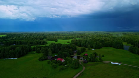 Revealing-Drone-View-of-Lush-Green-Homestead-and-Forest-with-Deep-Blue-Sky