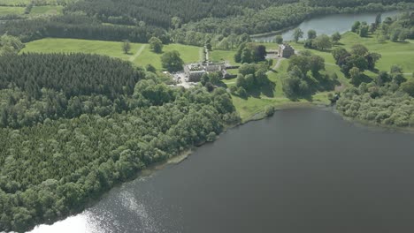 Aerial-View-of-Bellamount-Castle-And-Forest-By-The-Lake-In-Summer-In-Cootehill,-County-Cavan,-Ireland