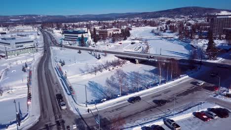 4K-Drone-Video-of-Barnette-Street-and-Cushman-Street-Bridges-over-Frozen-Chena-River-in-Downtown-Fairbanks-Alaska-on-Snowy-Winter-Day