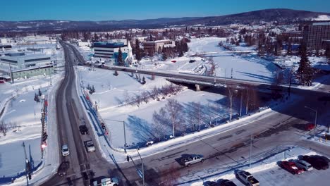 4K-Drone-Video-of-Barnette-Street-Bridge-over-Frozen-Chena-River-in-Downtown-Fairbanks-Alaska-on-Snowy-Winter-Day