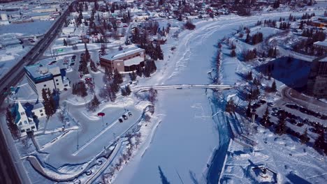 4K-Drone-Video-of-The-William-Ransom-Wood-Centennial-Bridge-over-Frozen-Chena-River-in-Downtown-Fairbanks-Alaska-on-Snowy-Winter-Day