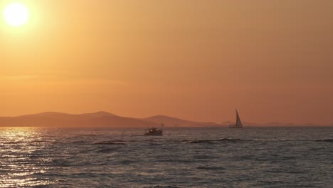 Sunset-at-Zadar-Riva-Croatia-with-boats,-sail-boats-and-people-walking