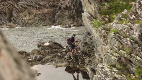 Hand-held-shot-of-a-fisherman-fishing-in-the-small-tide-pools-at-Polperro