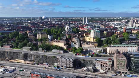 Church-of-Katarina-in-Stockholm,-Sweden,-Drone-fly-over-water-and-tower-in-city-central