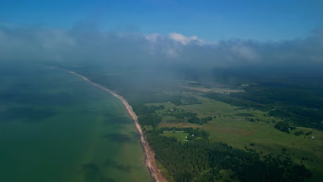 Rural-landscape-and-Latvia-coastline-from-above-clouds,-aerial-drone-view