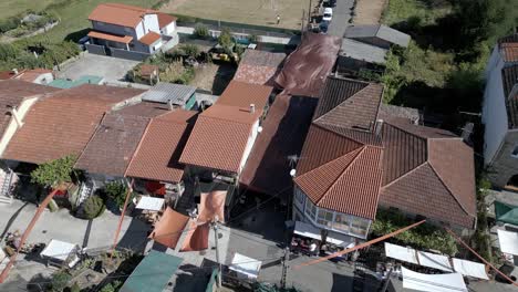 Aeial-static-high-angle-view-of-tarps-covering-street-providing-shade-at-ethnographic-festival-pereiro-de-aguiar-lonoa-spain
