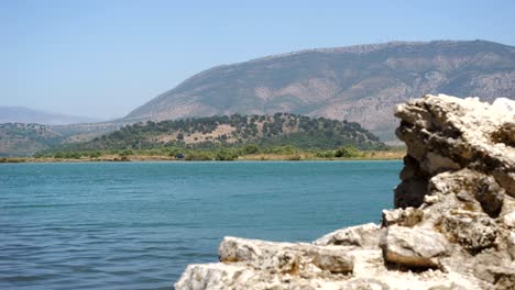 Butrint,-Albania,-view-of-the-mountain-and-lake,-with-ancient-ruins-in-the-foreground