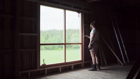 Man-Installing-Wooden-Window-Sill-Inside-The-House-In-Indre-Fosen,-Norway