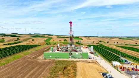 Drilling-Rig-Among-Agricultural-Fields-In-Austria---aerial-drone-shot