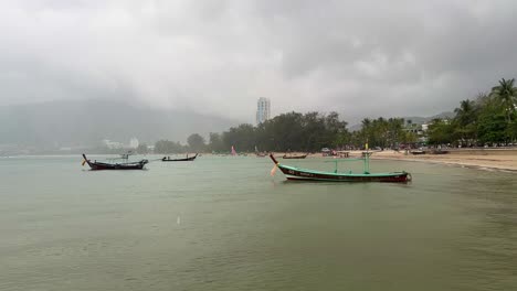 South-of-Thailand-on-a-rainy-and-cloudy-day-close-to-Freedom-Beach-in-Phuket-with-long-tail-boat