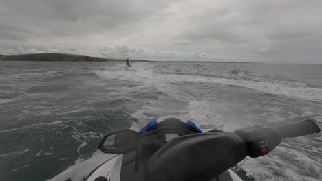 POV-shot-of-a-jet-ski-instructor-racing-across-make-a-large-wake-off-the-coast-of-Newquay
