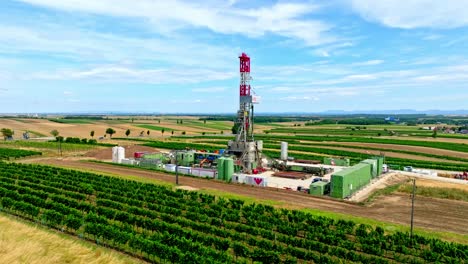 Oil-Drilling-Rig-And-Gas-Station-Industry-In-The-Countryside-Of-Austria---aerial-drone-shot