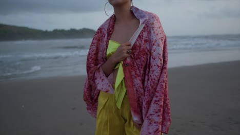 A-hot-Indian-model-girl-in-a-yellow-dress-is-posing-for-a-photo-shoot-on-a-beach-on-a-hot-summer-day