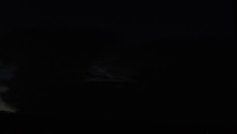 Slow-Motion-of-a-distant-cloud-at-night-with-heady-lightning-happening-inside-it