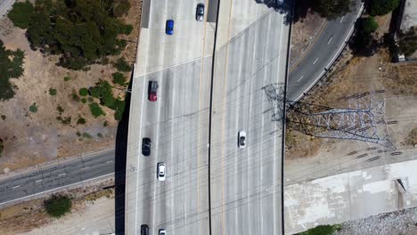 Birds-eye-view-drone-shot-cars-driving-on-freeway-for-summer-vacation