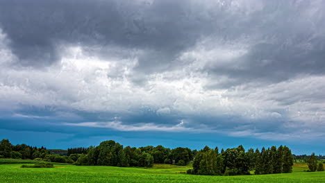 Cloudy-Sky-Over-Rural-Field-With-Lush-Trees