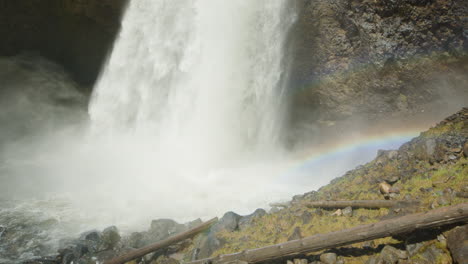 Tilt-down-shot-of-Moul-Falls-water-flow-with-rainbow,-Canada