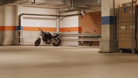 Wide-shot-of-a-black-Ducati-motorbike-in-a-garage