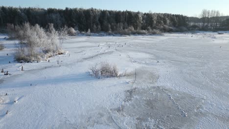 Flying-towards-the-treeline-from-a-frozen-lake