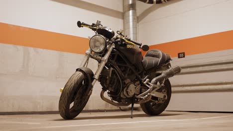 Full-shot-of-a-black-Ducati-motorbike-in-a-garage