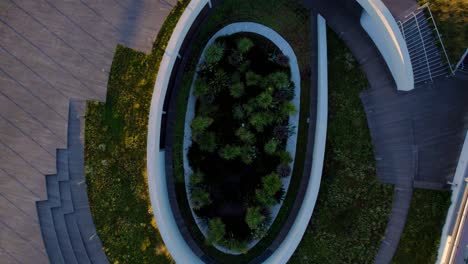 Aerial-view,-sunrise-over-the-green-roofed-Musée-de-la-Romanité-filled-with-grass-and-trees