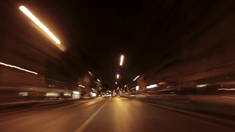Late-night-car-ride-timelapse-through-Paris,-France,-with-cars,-building-lights-and-street-lights-illuminating-the-scene