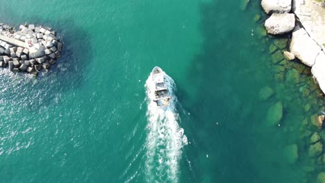 Cinematic-overhead-4K-drone-clip-following-a-fishing-boat-from-the-Mediterranean-to-the-of-port-de-Carro-in-Martigues-commune,-France