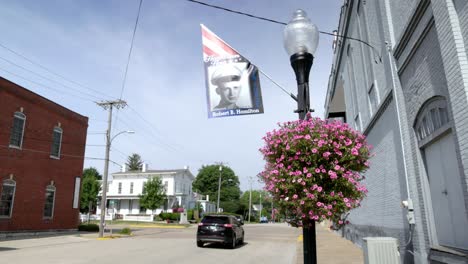 Hometown-Hero-banner-in-downtown-Geneseo,-Illinois-with-gimbal-video-walking-forward