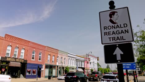 Ronald-Reagan-trail-sign-in-downtown-Princeton,-Illinois-with-gimbal-video-panning-left-to-right