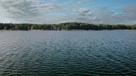 Panorama-Del-Lago-Con-Agua-Ondulante-Y-Denso-Bosque-De-árboles-En-Warmia,-Polonia
