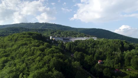 Aerial-Shot-of-Huge-Mountain-Resort-in-the-Middle-of-the-Forest-at-Summertime