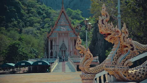 Dragon-scupltures-at-the-entrance-to-a-temple-and-another-temple-in-the-background-between-the-mountains