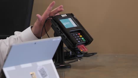 A-Female-Customer-Uses-a-Digital-Point-of-Sale-Terminal-Payment-Machine-to-Process-her-Expensive-Retail-Credit-Card-Purchase-Transaction