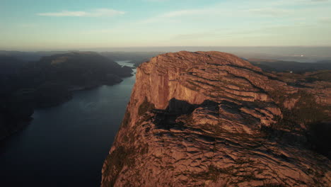 Breathtaking-Aerial-View-of-an-impressive-Cliff-in-Norway,-Sunrise-Atmosphere-in-the-Lysefjorden,-Preikestolen,-Pulpit-Rock